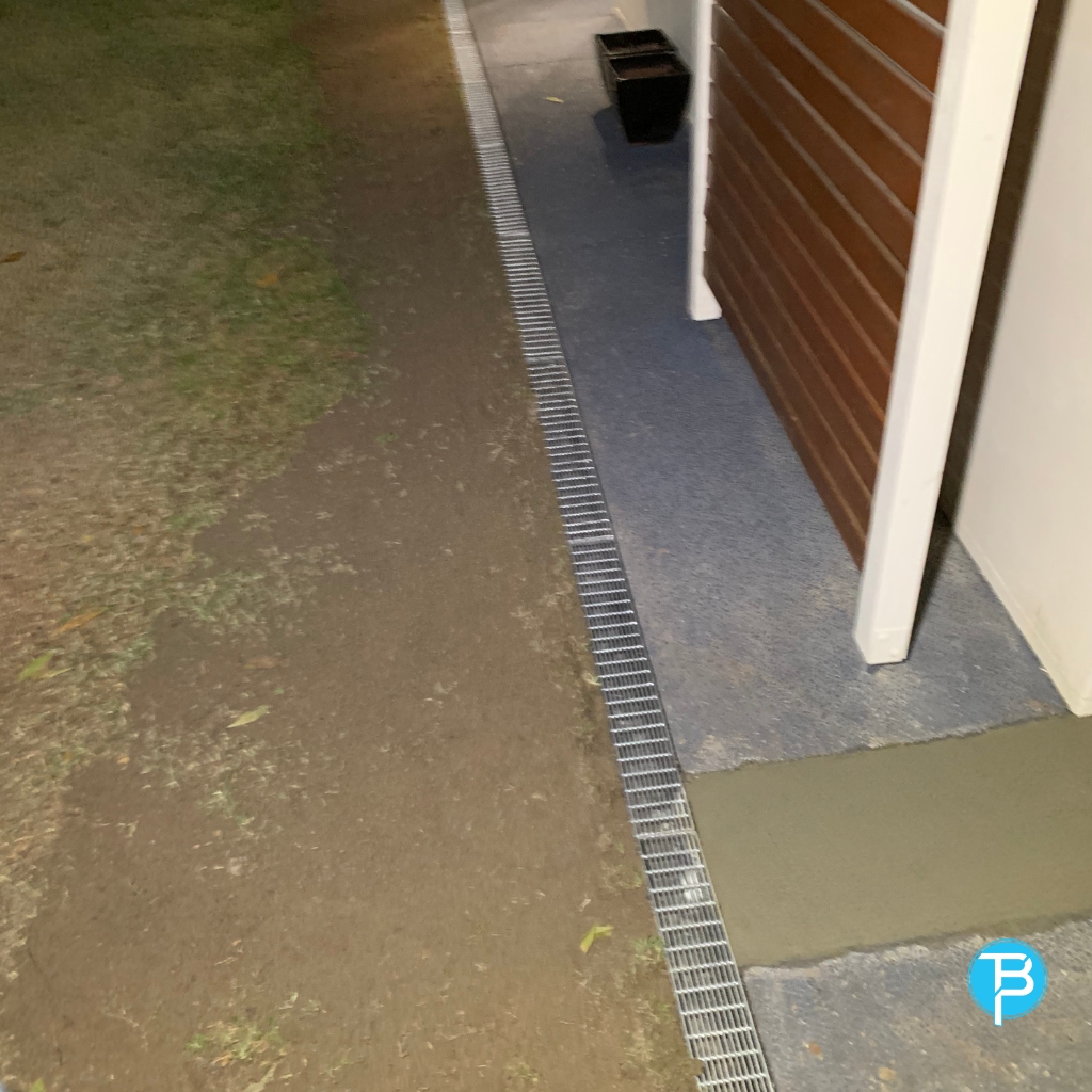 a drainage grate in a driveway